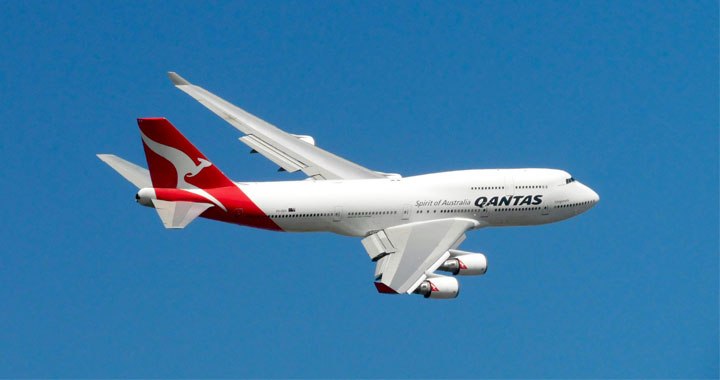 Qantas Airlines plane flying in the Sky.